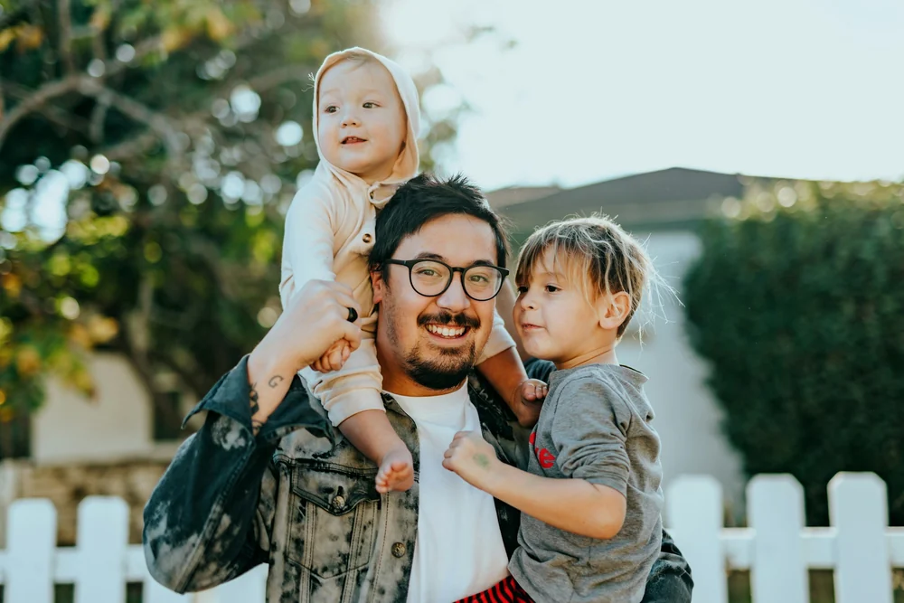 A father with two children outdoors